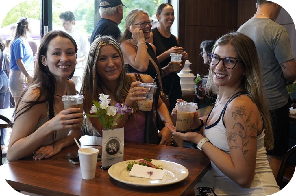 Guests smiling together at the cafe